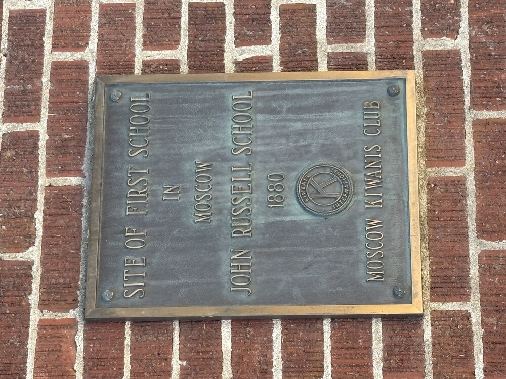 Bronze plaque reading Site of First School In Moscow, John Russell School, 1880